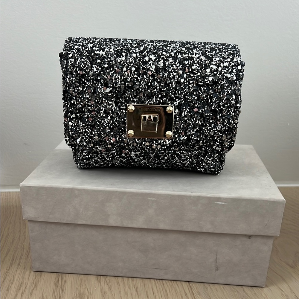 Authentic Jimmy Choo clutch. Comes with strap. Worn once.